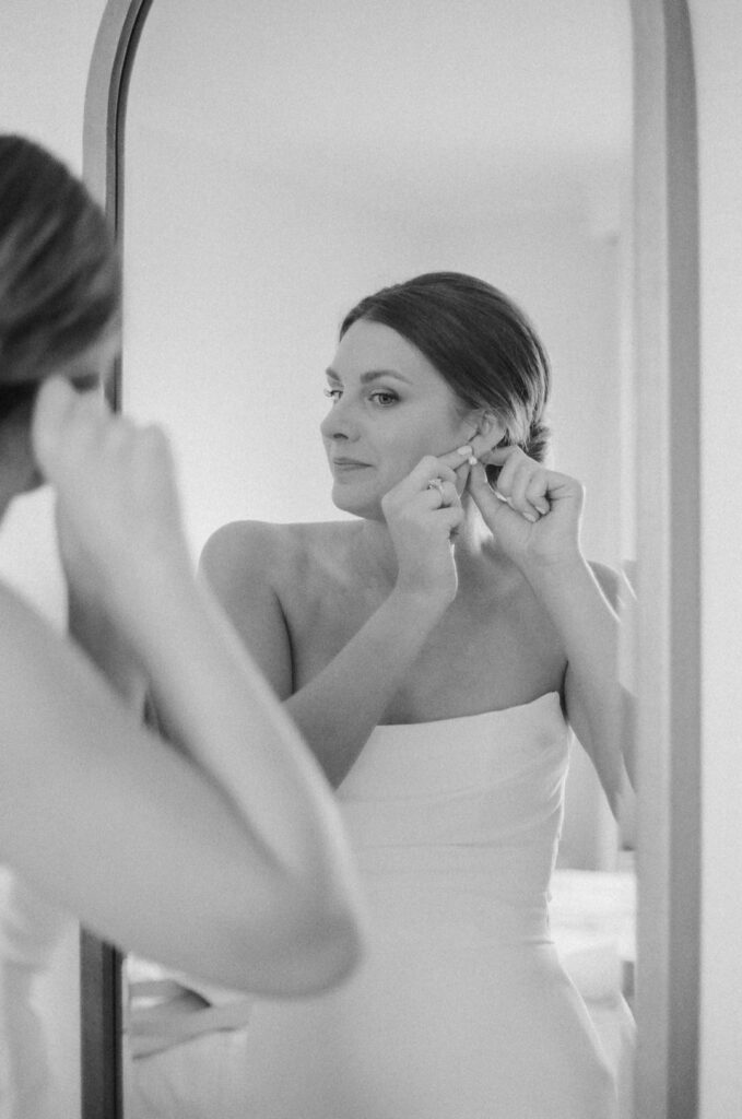 bride putting in earrings