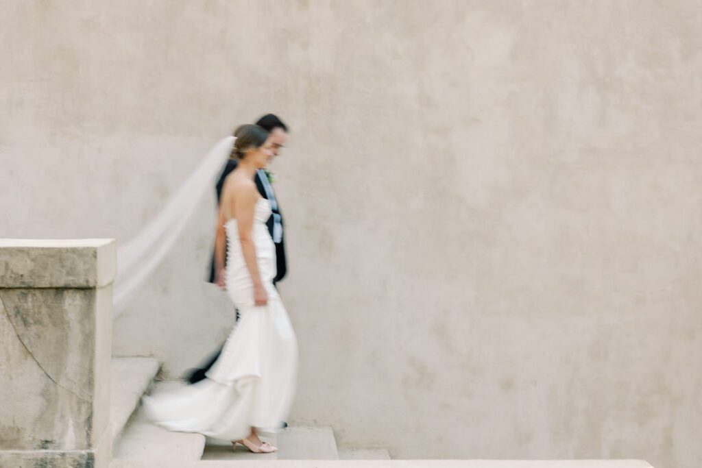 bride and groom walking down stairs at The Swan House Atlanta GA