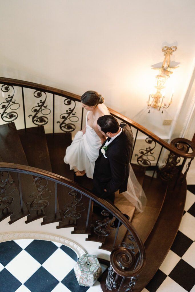 bride and groom walking up stairs at The Swan House Atlanta GA