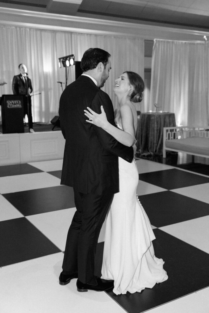 black and white of bride and groom dancing