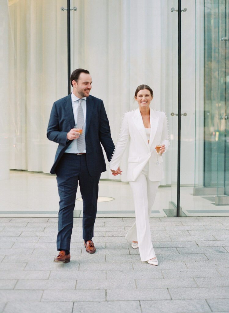 bride and groom holding hands