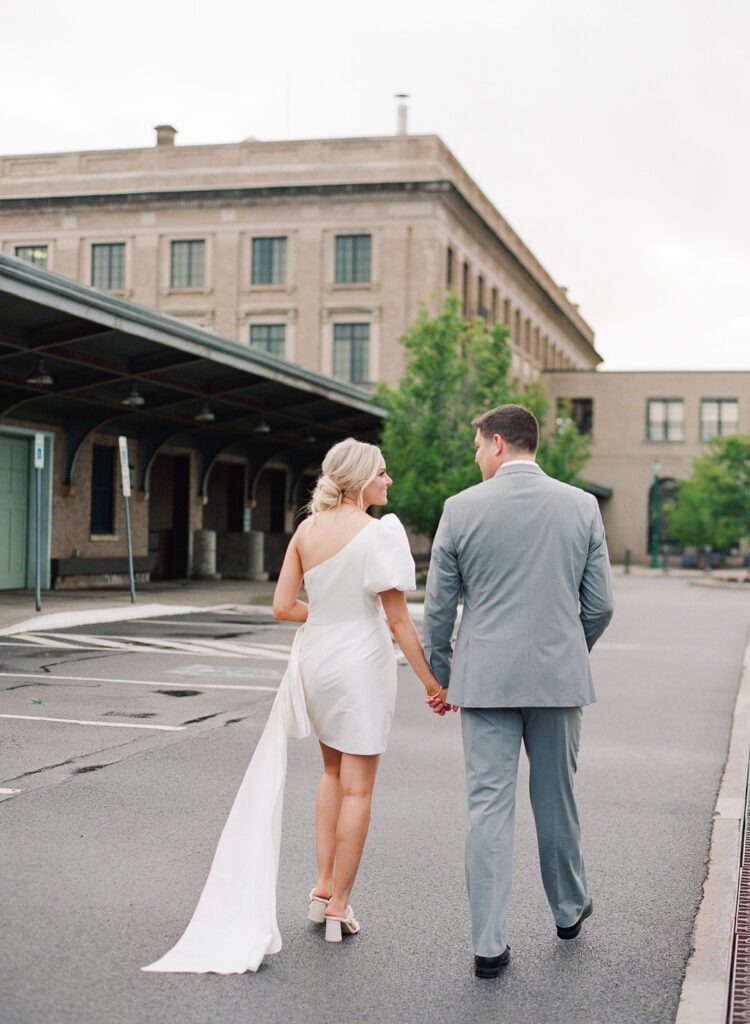 bride and groom walking holding hands