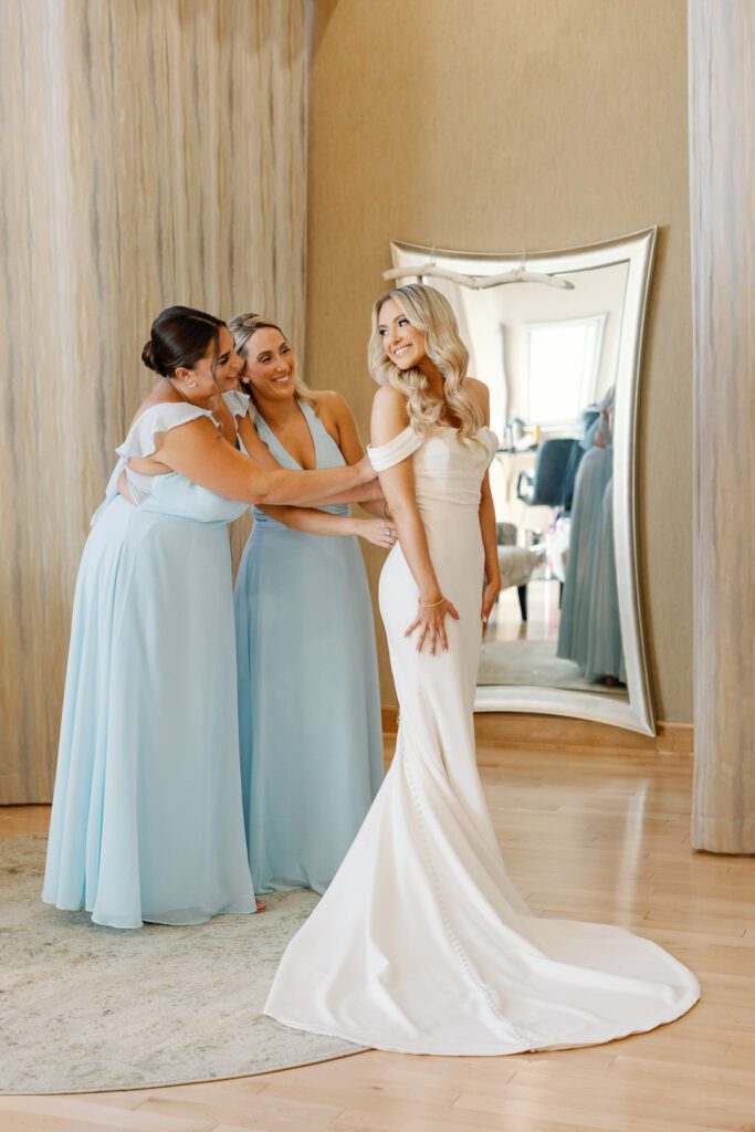 bridesmaids helping bride get ready