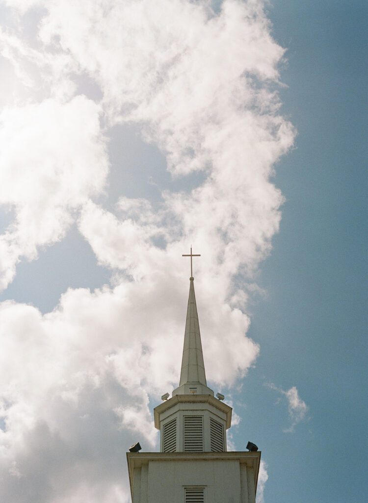 church steeple with cloudy sky