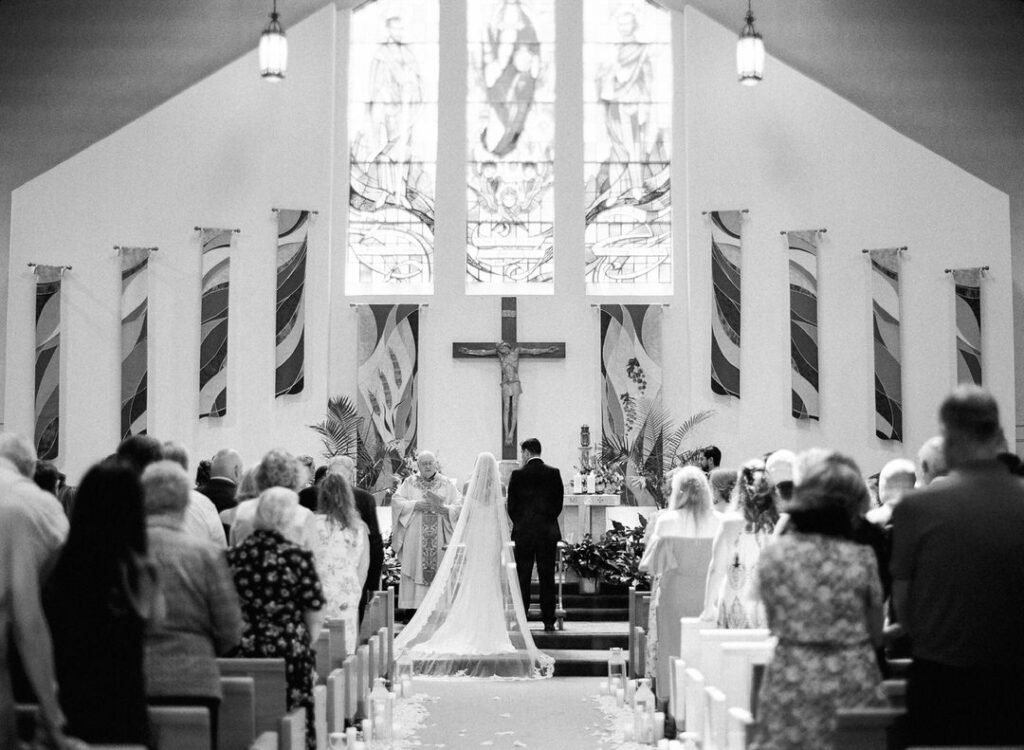 black and white of bride and groom at alter of ceremony