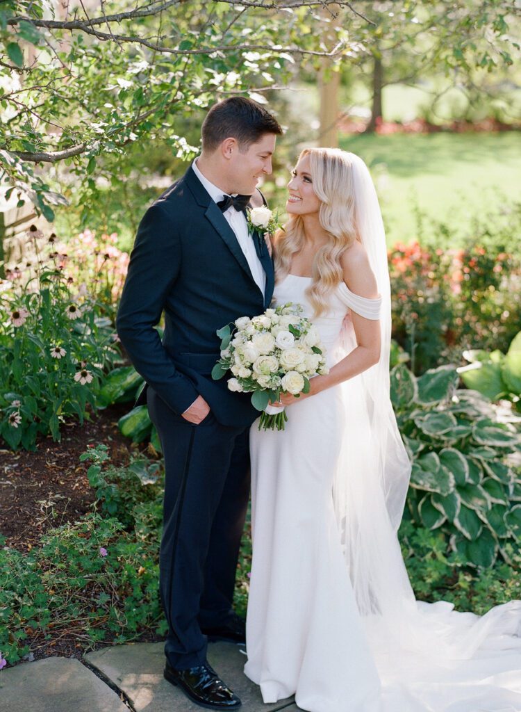 bride and groom smiling at each other