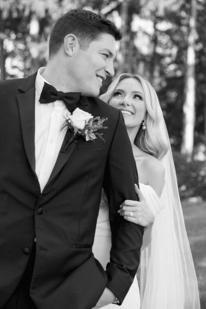 black and white of bride and groom looking at each other