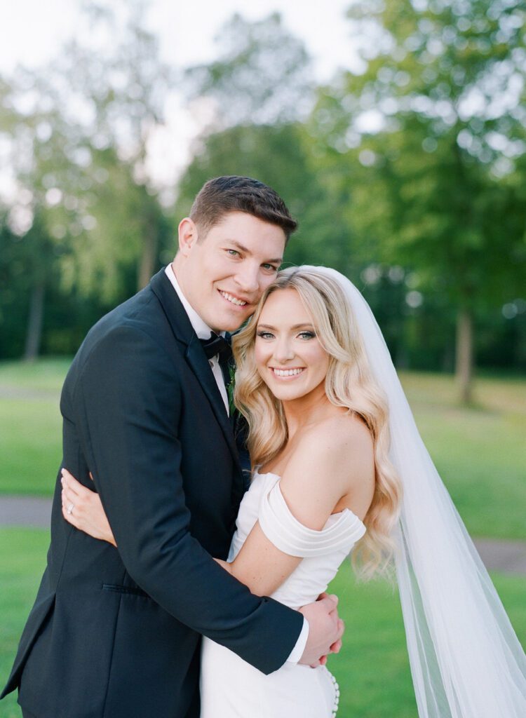 bride and groom smiling at camera