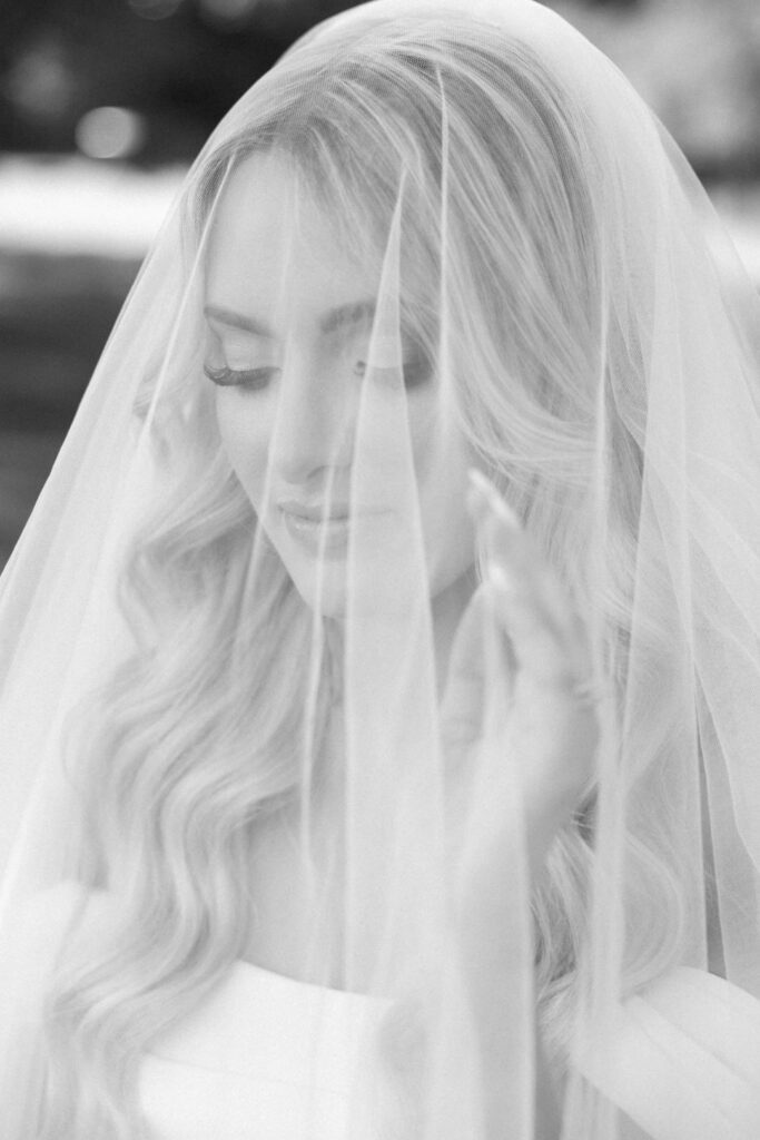 black and white of bride with veil