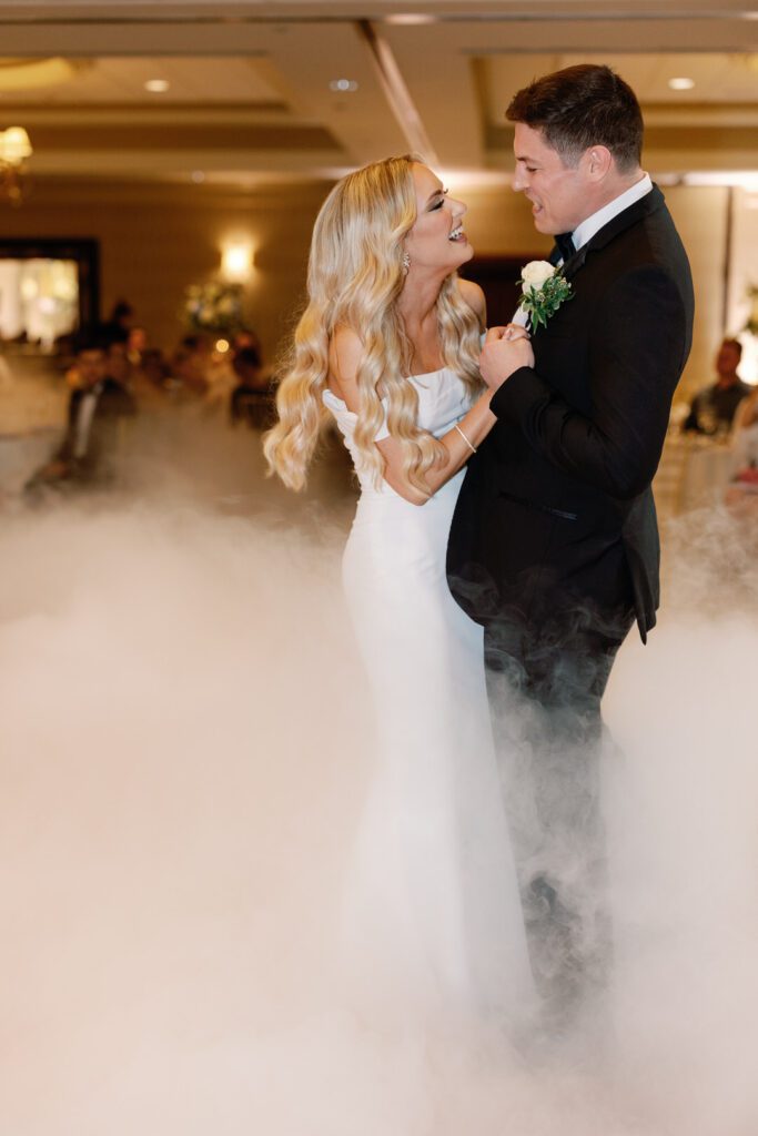 bride and groom first dance in fog