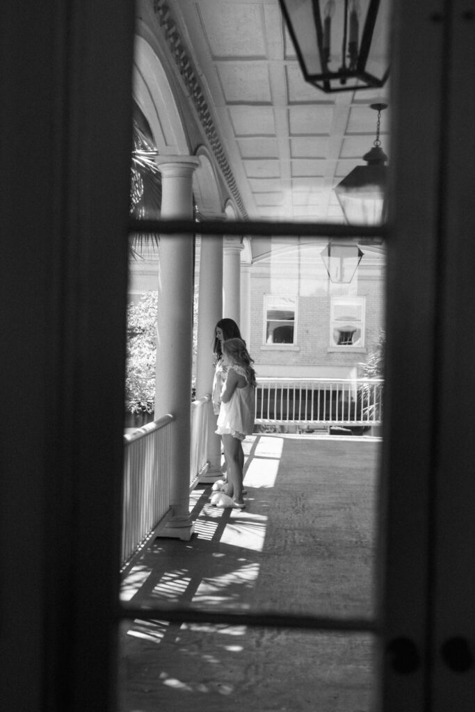 black and white of bride looking over balcony