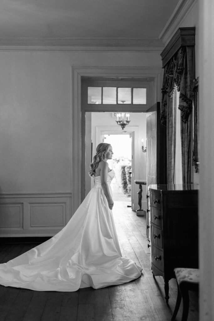 black and white of bride looking out window at William Aiken House Photos