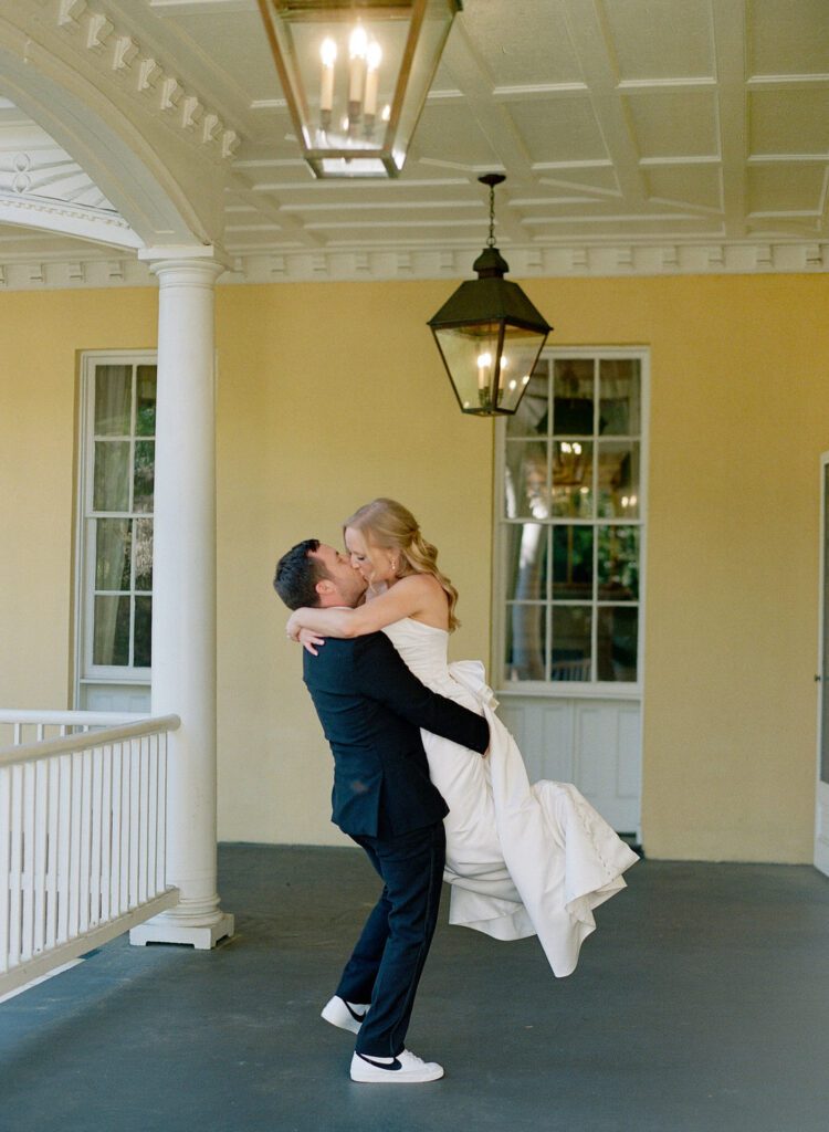 groom picking up bride kissing