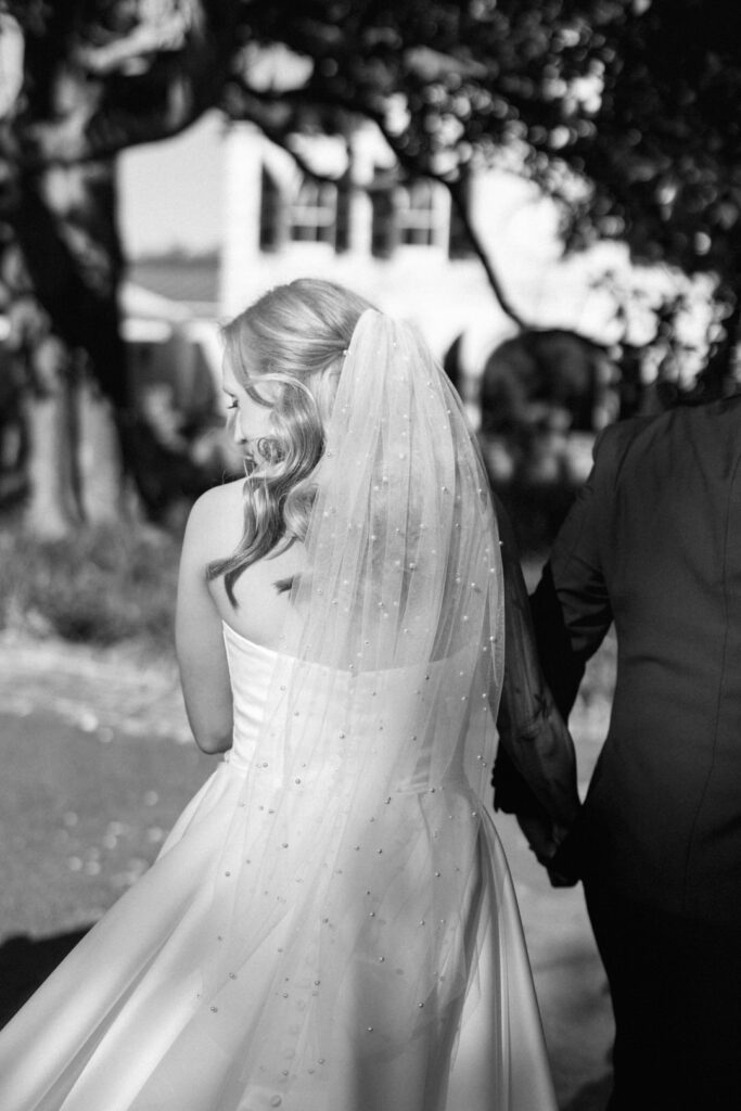 Black and white of bride with pearl veil