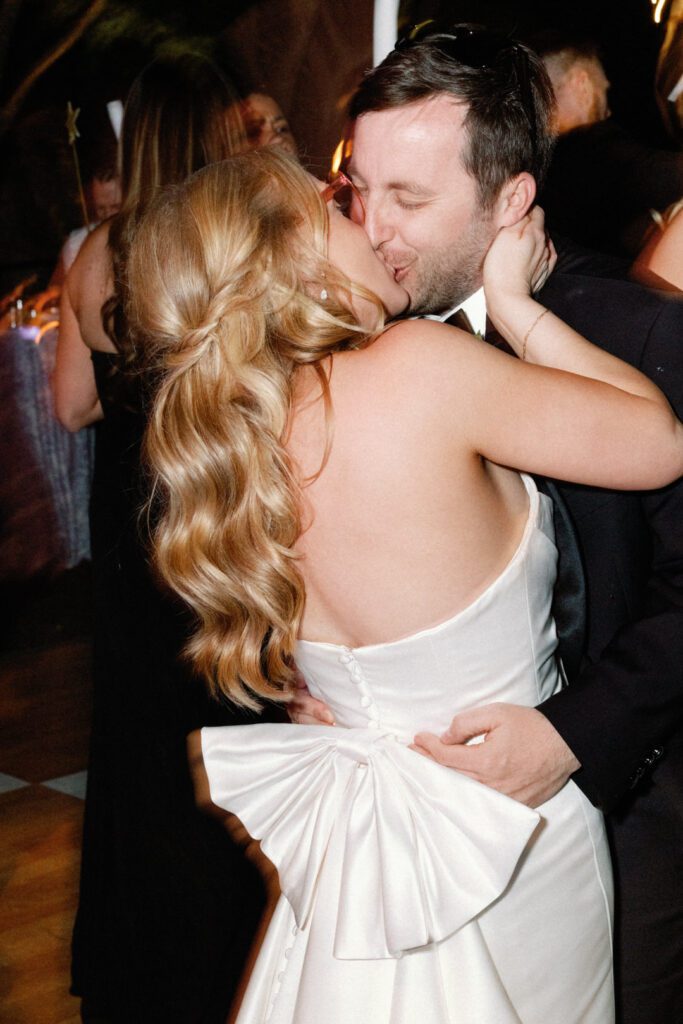 bride and groom kissing on dance floor