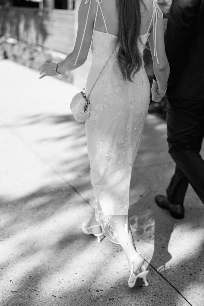 black and white of bride and groom walking