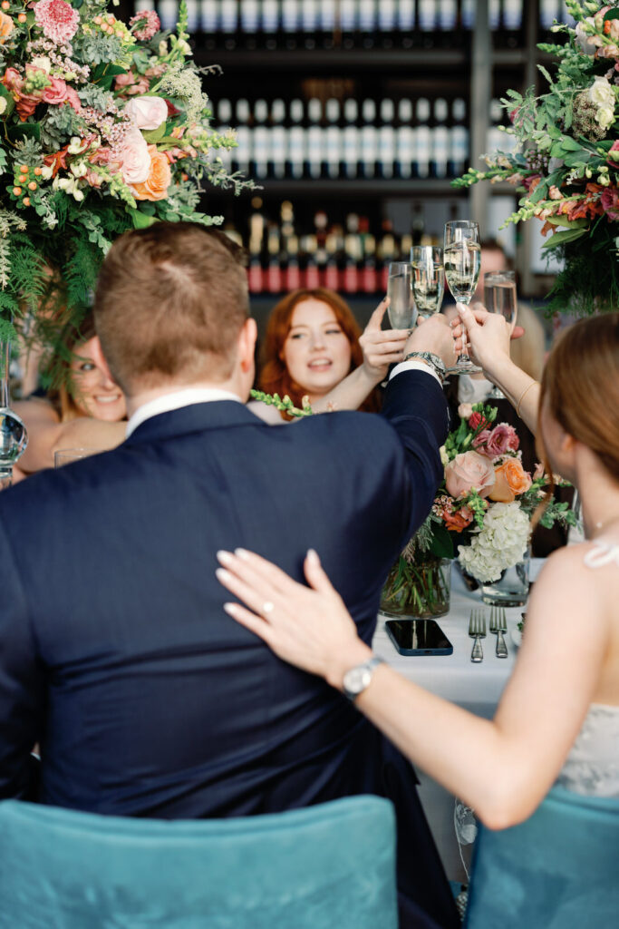 bride and groom toasting with guests