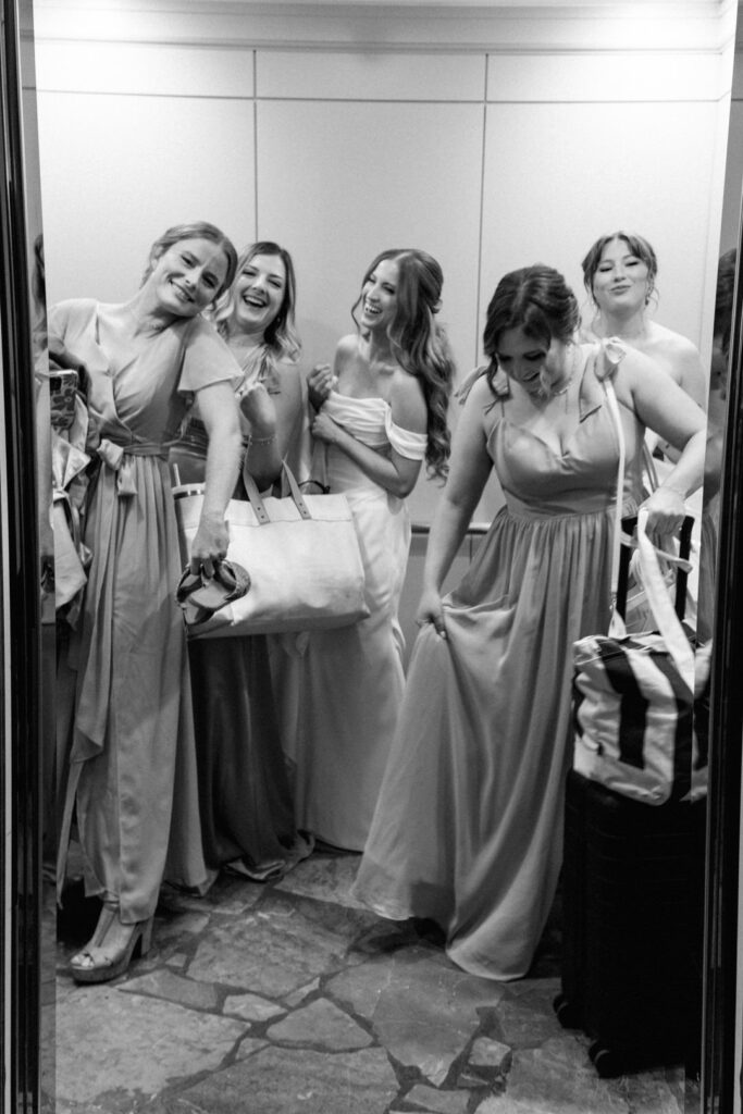 bride with bridesmaids in hotel elevator