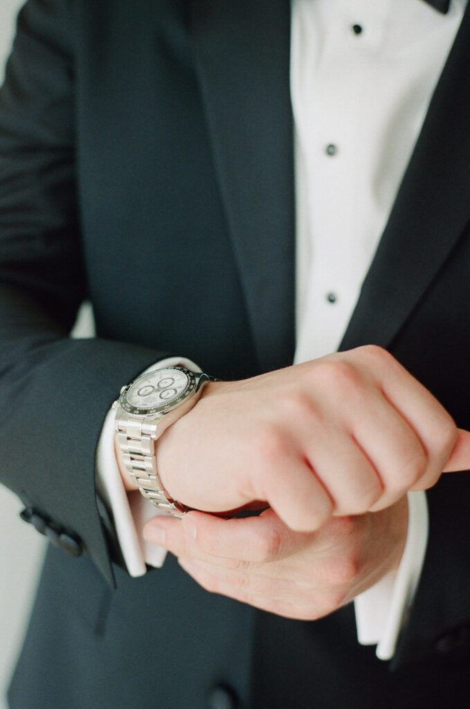 groom putting on watch