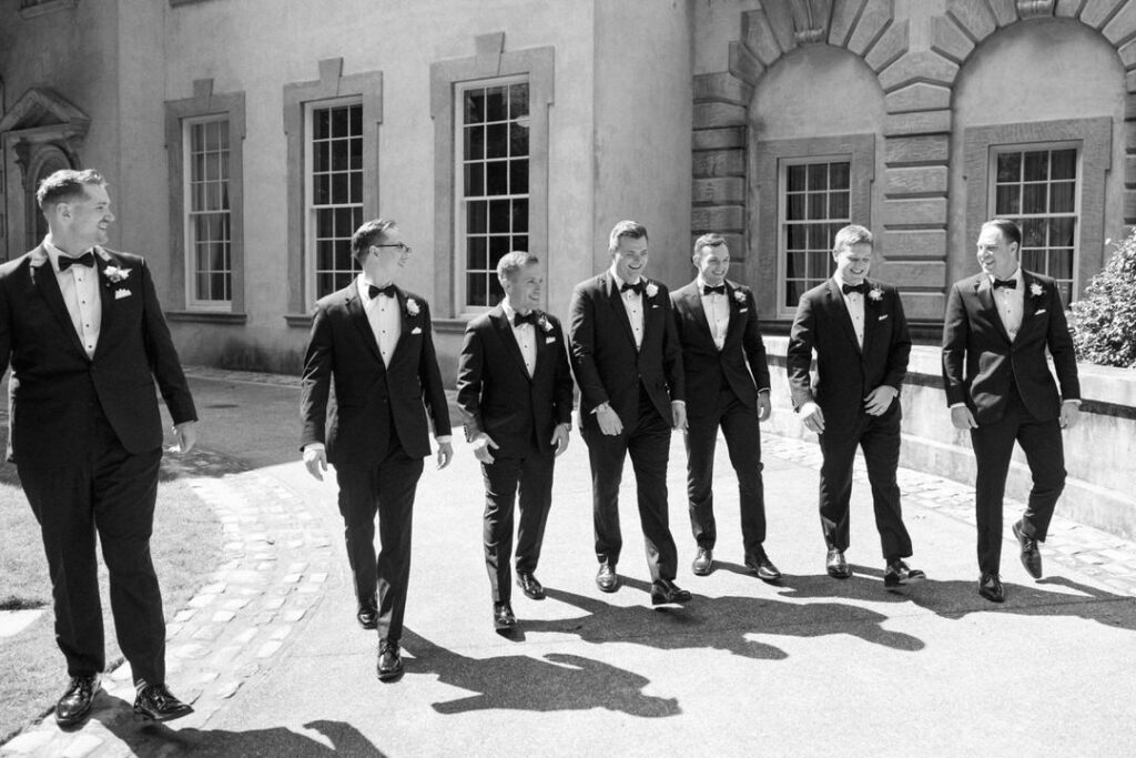 groom with groomsmen walking toward camera at Swan House in Atlanta