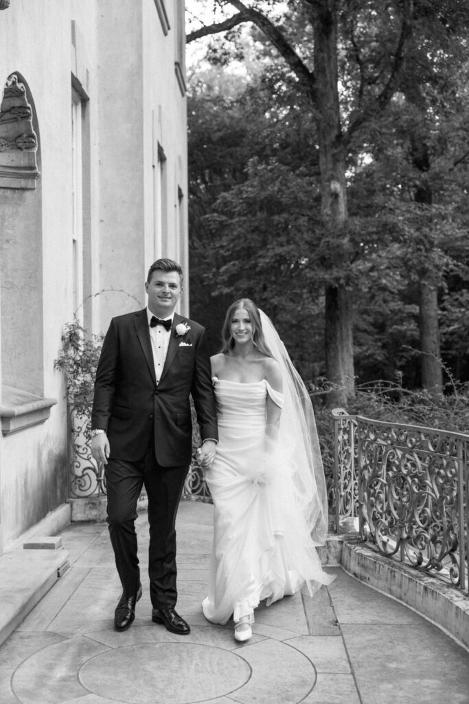 black and white of bride and groom walking toward camera