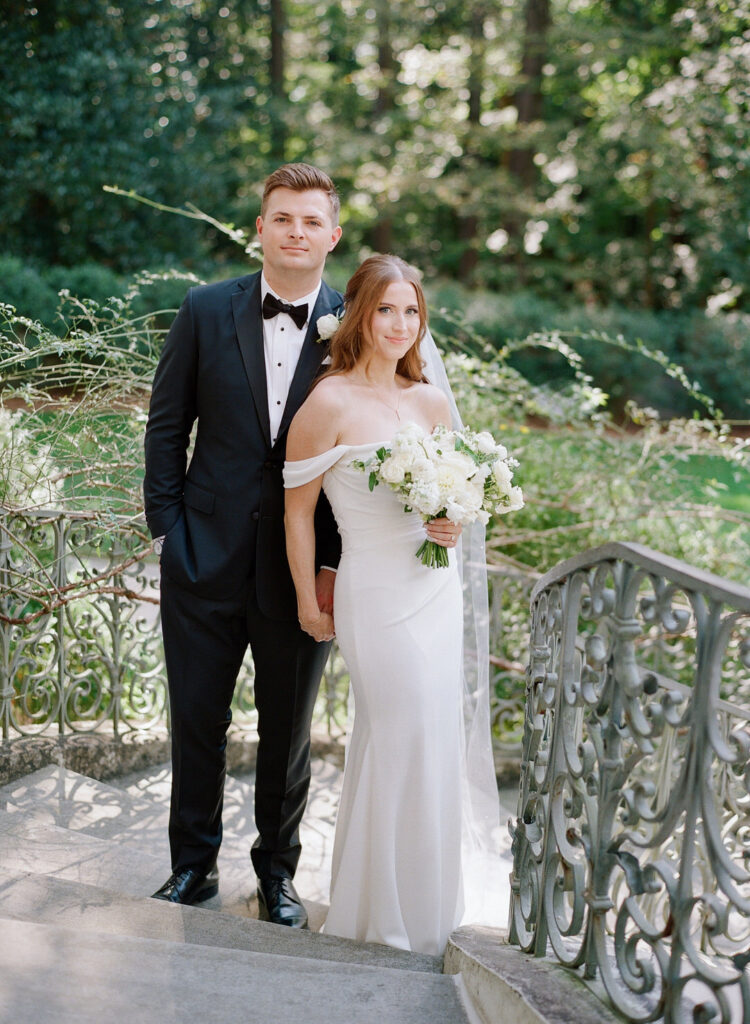 bride and groom holding hands on Swan House Stairs