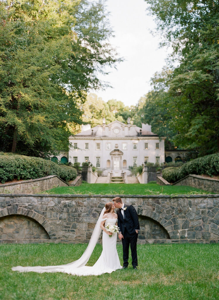 Bride and Groom Kissing on lower lawn at Swan House Atlanta