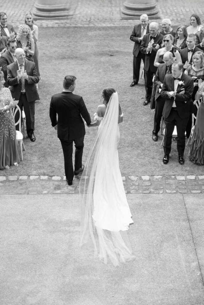 black and white of bride and groom exiting ceremony