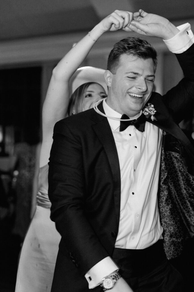 black and white of groom dancing