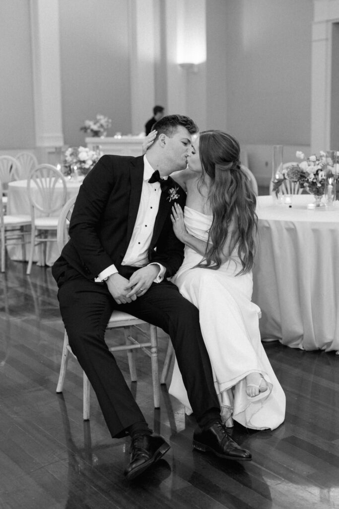 bride and groom kissing at end of wedding reception