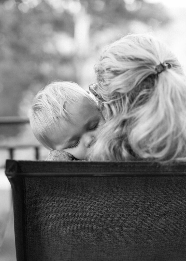 black and white of baby sleeping on his mom