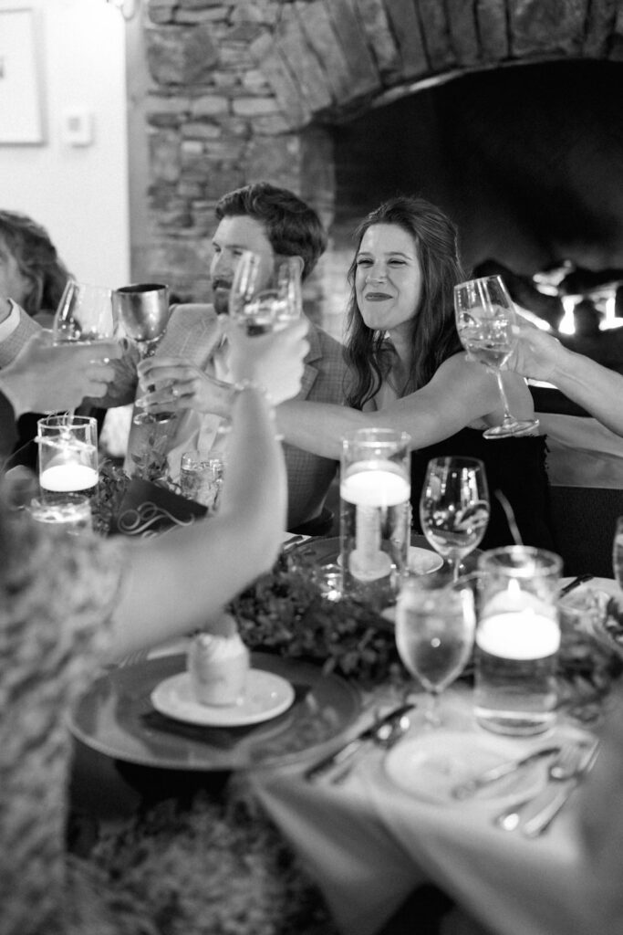 black and white of toasting at wedding rehearsal dinner