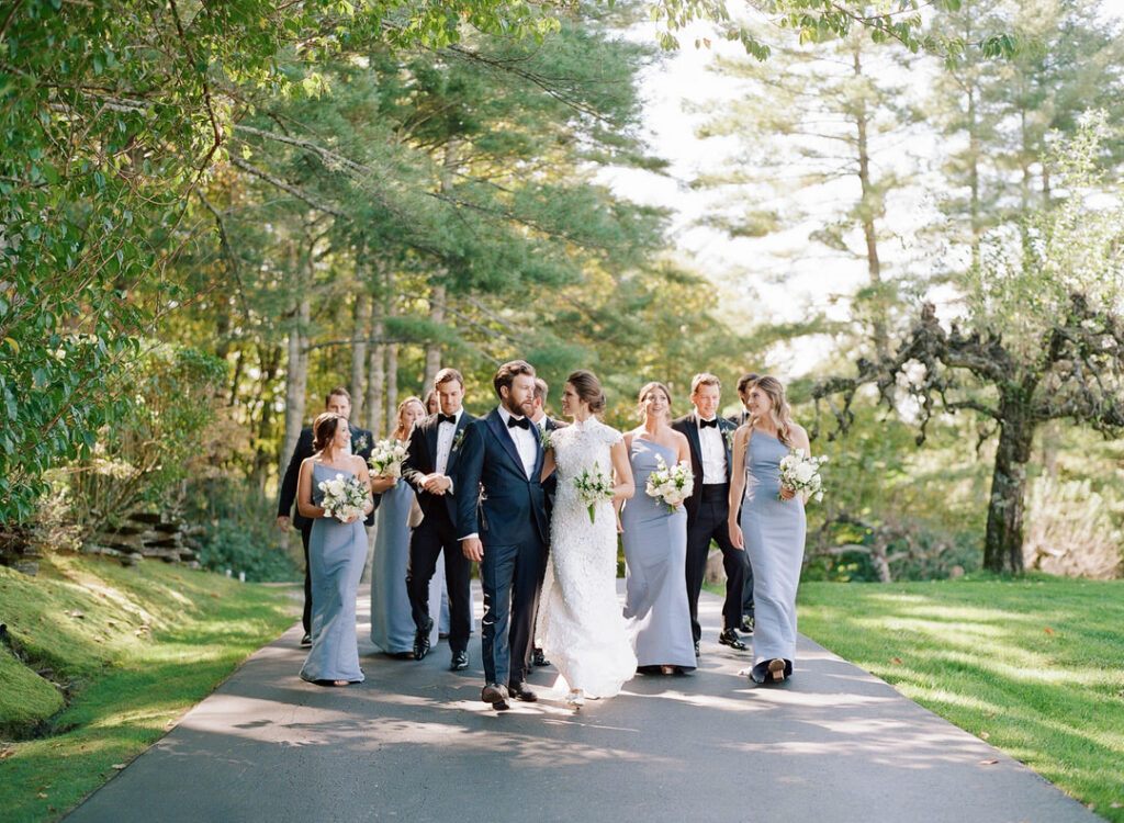 bride and groom walking with bridesmaids and groomsmen