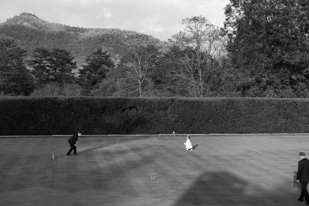 black and white of people playing on croquet court