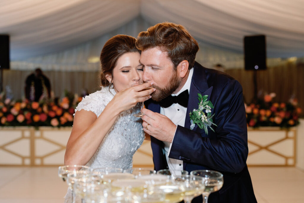 bride and groom drinking champagne