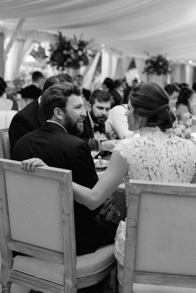 black and white of bride and groom at wedding reception