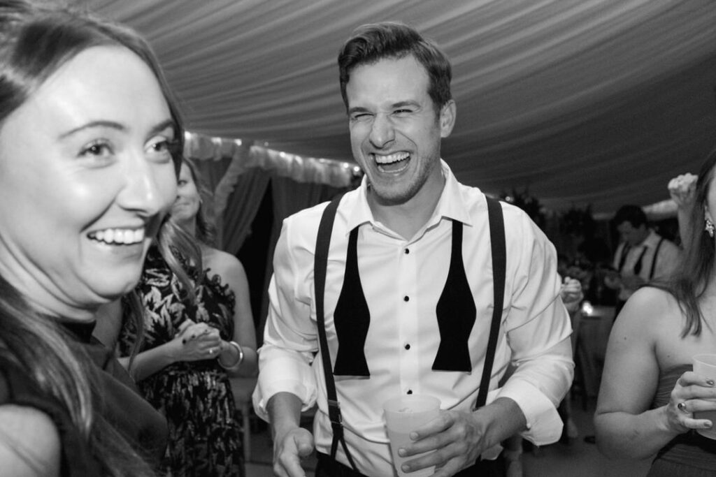 black and white of wedding guest laughing