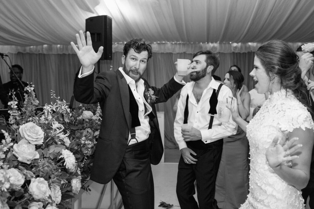 black and white of bride and groom dancing at wedding reception