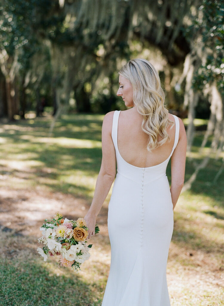 bride from back holding flowers