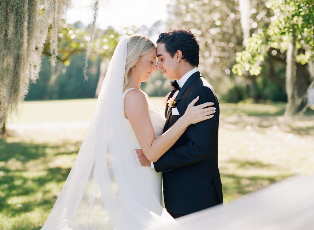 bride and groom nose-to-nose hugging