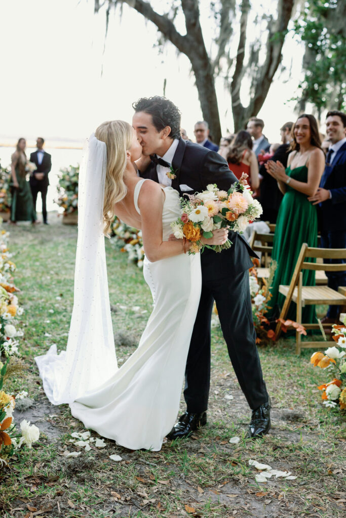 bride and groom ceremony aisle kiss