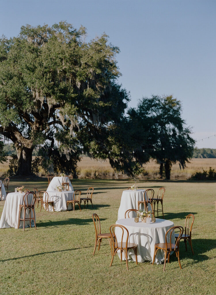 cocktail hour tables in field at Runnymede Charleston