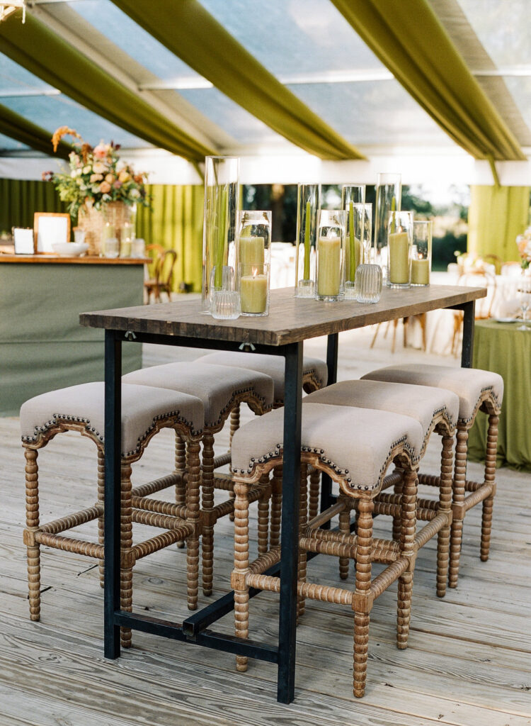 high tables and stools at tented wedding reception