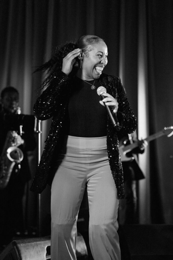 black and white of band singer laughing