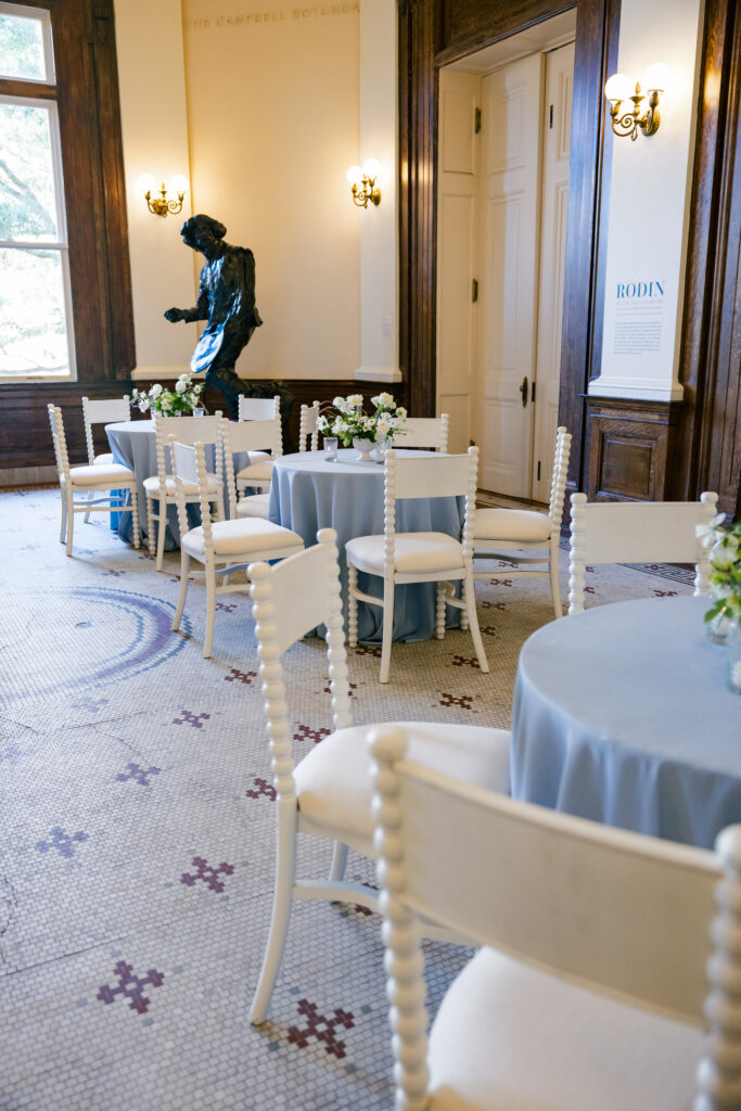 Seating for a wedding cocktail hour at The Gibbes Museum of Art Rotunda with Rodin sculpture in the background.