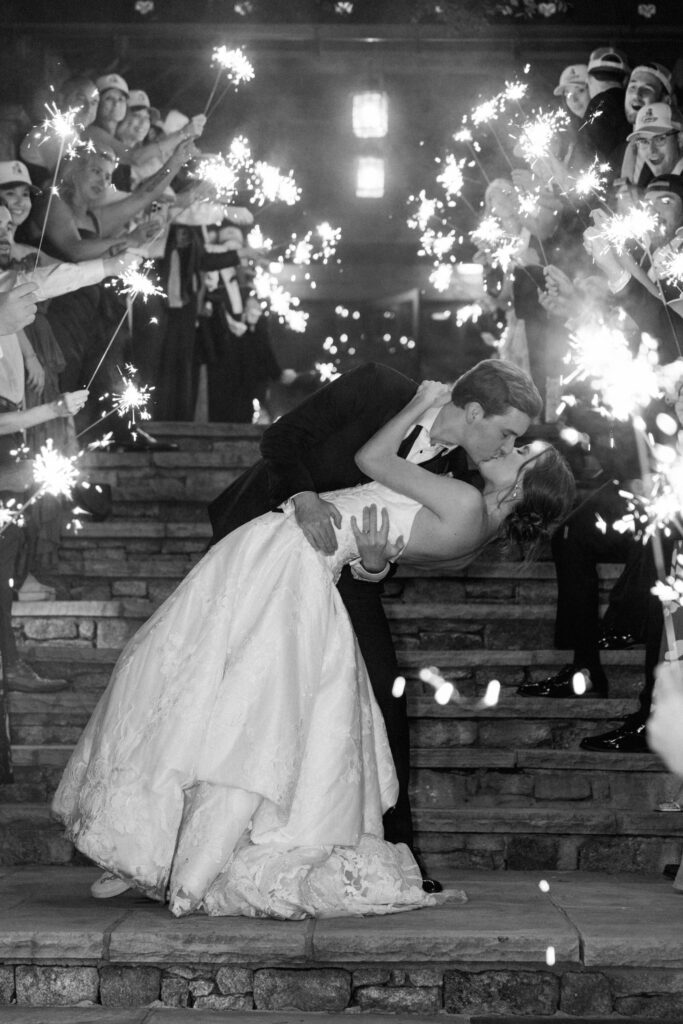 Bride and Groom kissing during their sparkler wedding reception exit at the Old Edwards Inn farm 