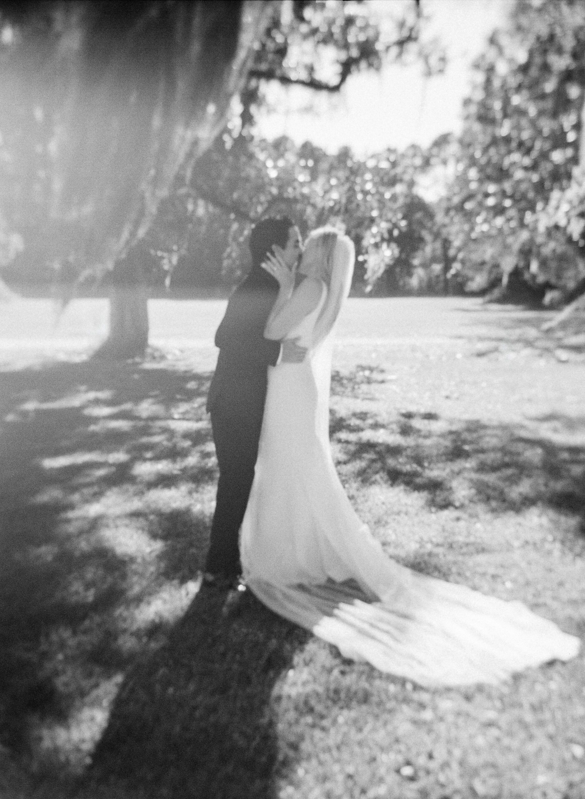 Black and White of Bride and Groom Kissing at their wedding