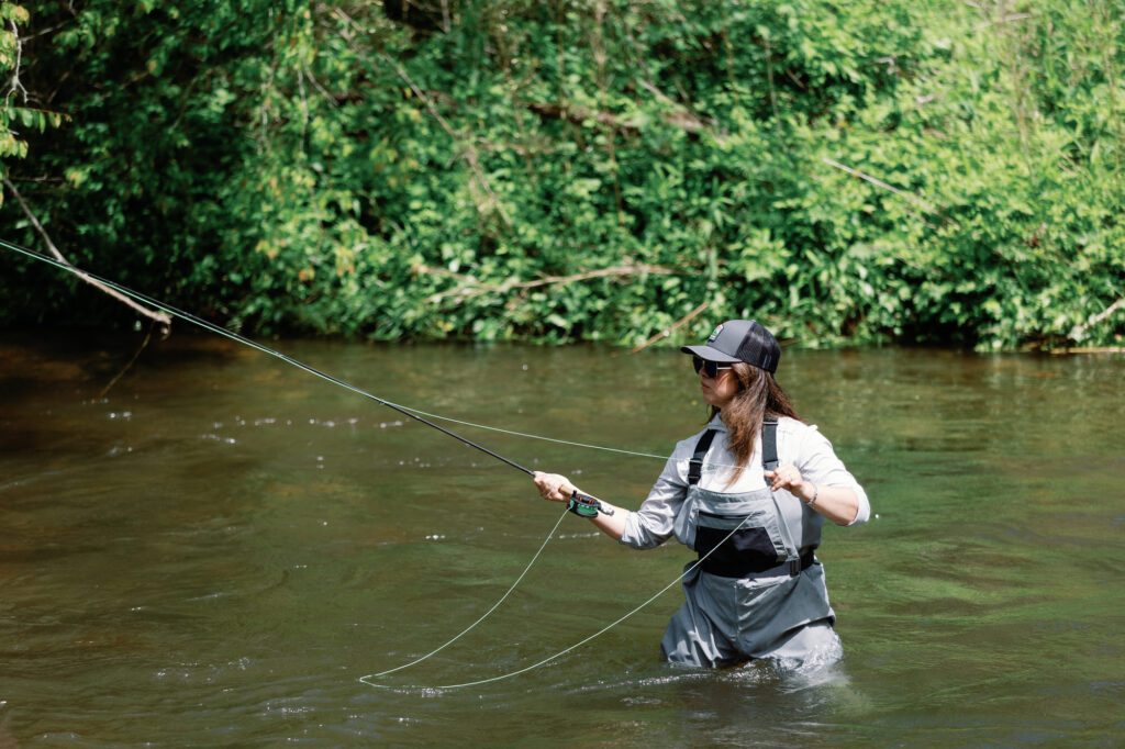 woman fly fishing in river