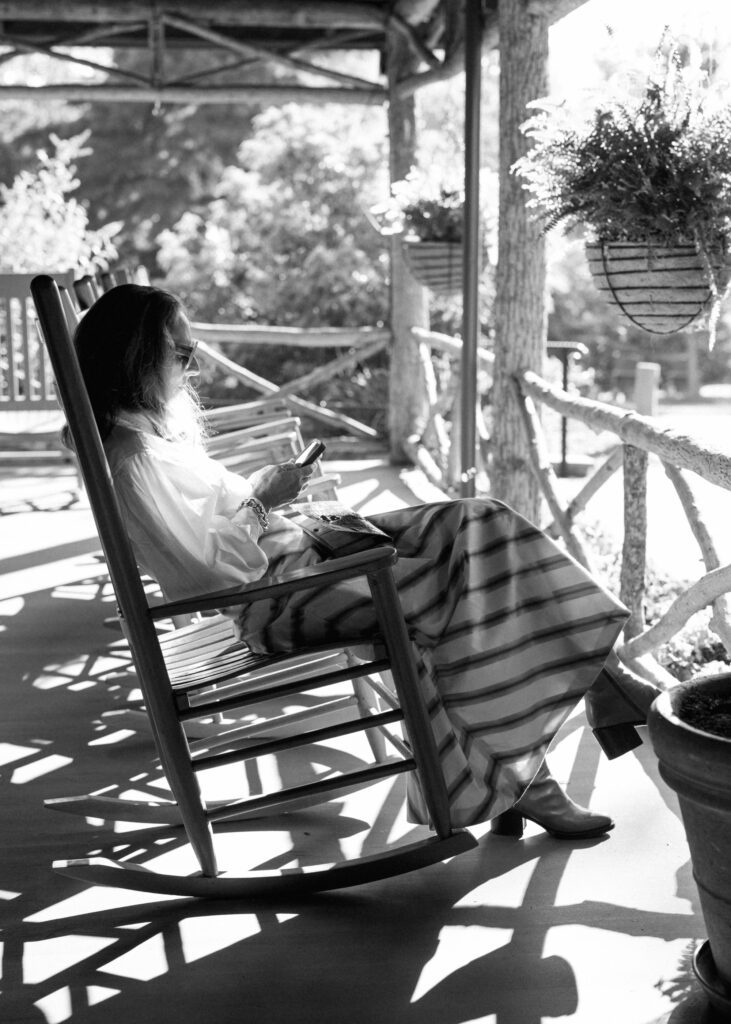 lady sitting in rocking chair at high hampton resort wedding venue